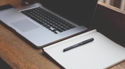 自媒体创作者在家庭工作室内整理图文内容，笔记本屏幕显示图片优化工具界面